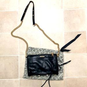 Black handbag with gold chain strap